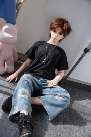 full-silicone-male-doll-uk-miles-seated-jeans-pink-bear